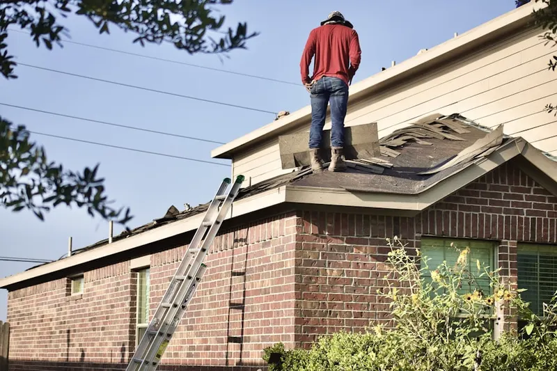 Professional roofer working on a residential roof in La Grande
